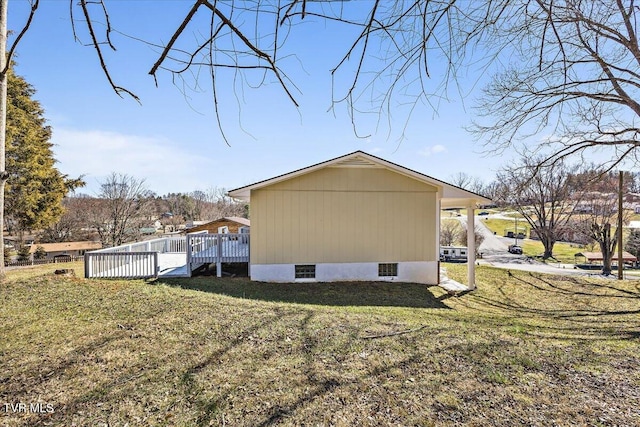 view of home's exterior featuring a deck and a lawn