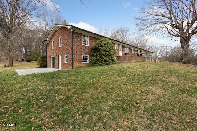 view of home's exterior featuring driveway, a lawn, an attached garage, and brick siding