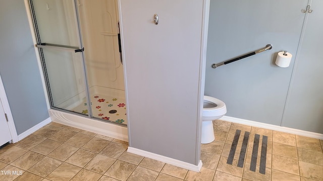 full bath with toilet, a stall shower, baseboards, and tile patterned floors