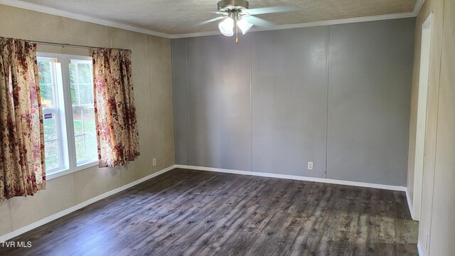 spare room with crown molding, plenty of natural light, dark wood finished floors, and ceiling fan