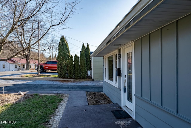 view of home's exterior with driveway and board and batten siding