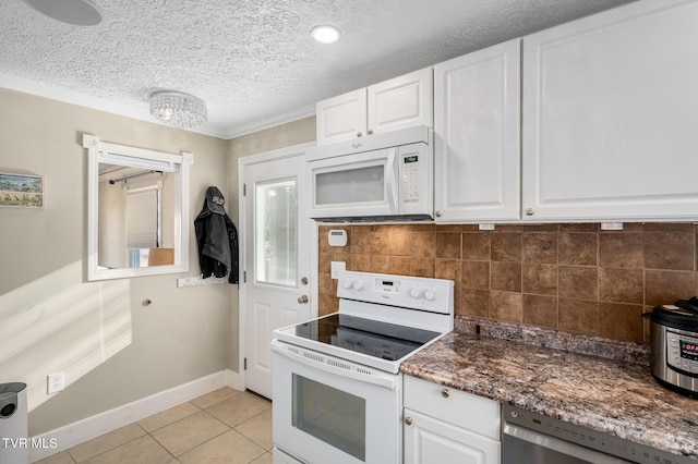 kitchen featuring white appliances, tasteful backsplash, light tile patterned floors, a textured ceiling, and white cabinetry