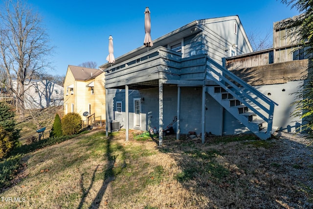 back of house featuring central AC unit, stairway, and a lawn