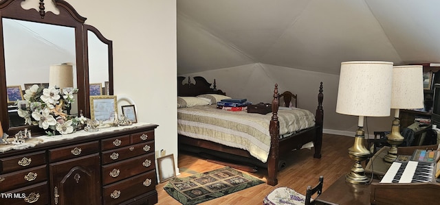 bedroom featuring lofted ceiling and light wood finished floors