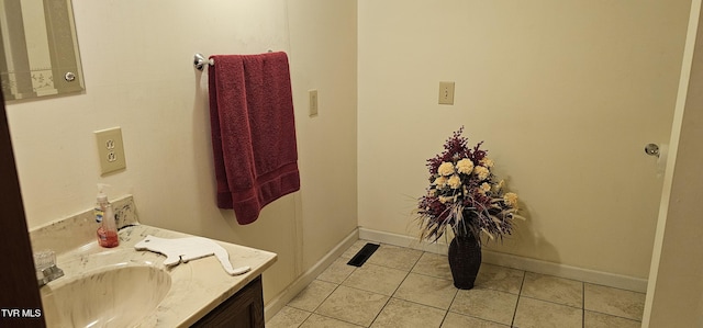 bathroom featuring tile patterned flooring, baseboards, and vanity