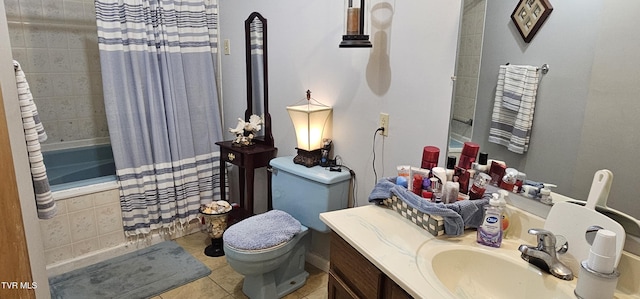 full bathroom with tiled shower / bath, vanity, toilet, and tile patterned floors