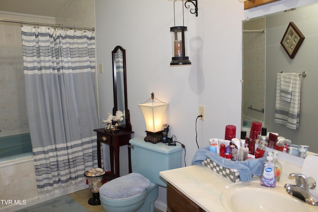 bathroom featuring tiled shower / bath combo, vanity, and toilet