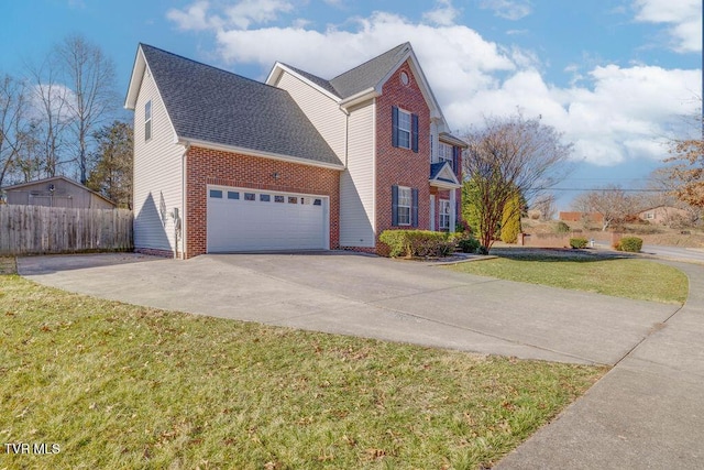 view of front of property with driveway, a garage, brick siding, fence, and a front yard