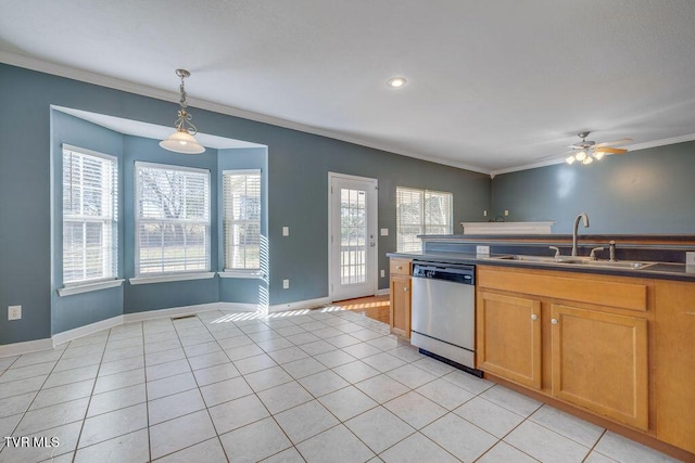 kitchen featuring dark countertops, ornamental molding, hanging light fixtures, stainless steel dishwasher, and a sink