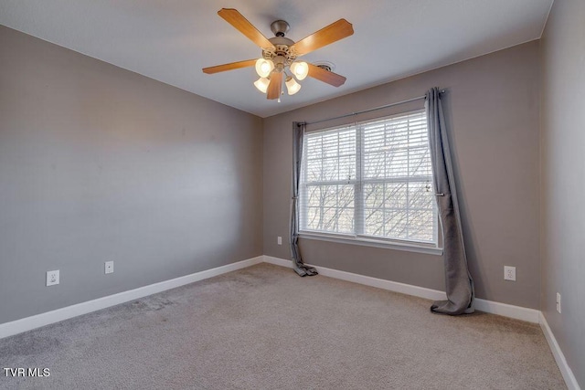 unfurnished room with light carpet, a ceiling fan, and baseboards