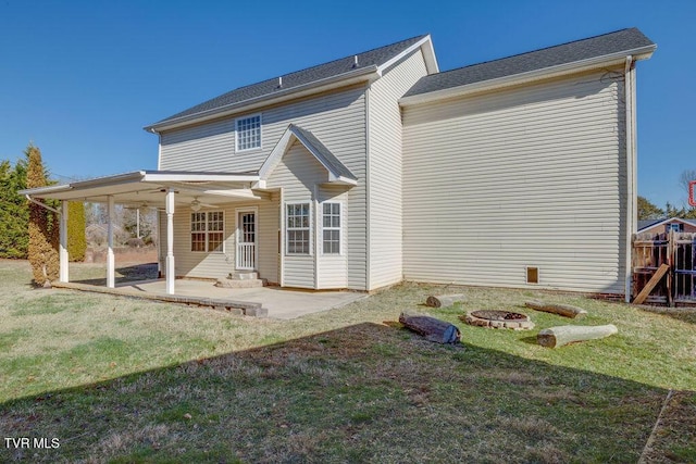 back of property with a playground, an outdoor fire pit, a lawn, and a patio area