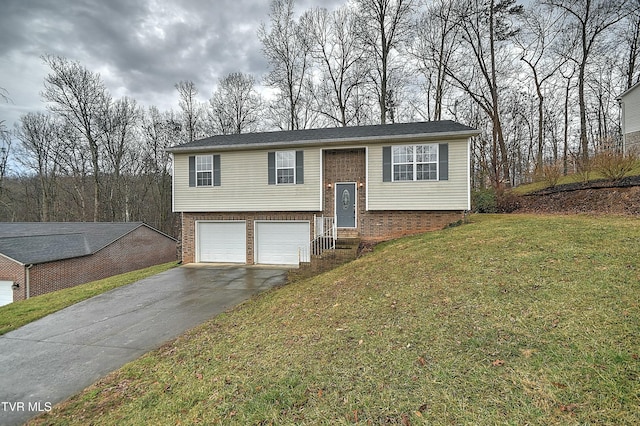 bi-level home featuring brick siding, a front yard, an attached garage, and aphalt driveway