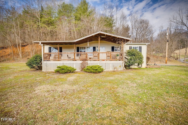 back of property featuring a porch and a yard