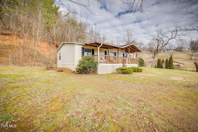 exterior space featuring covered porch and a front lawn