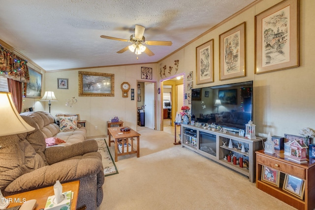 carpeted living room featuring a textured ceiling, a ceiling fan, vaulted ceiling, and crown molding