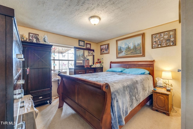 bedroom featuring carpet flooring and a textured ceiling