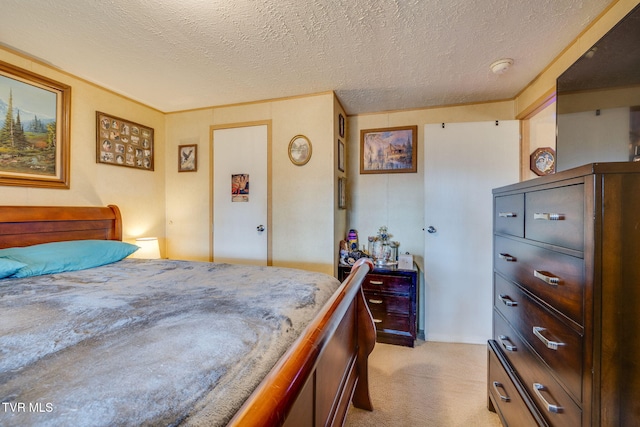 bedroom with light carpet and a textured ceiling