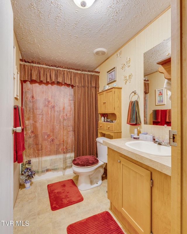 full bath featuring toilet, a textured ceiling, vanity, and a shower with curtain