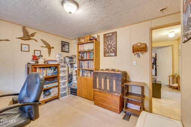 home office featuring a textured ceiling and carpet flooring