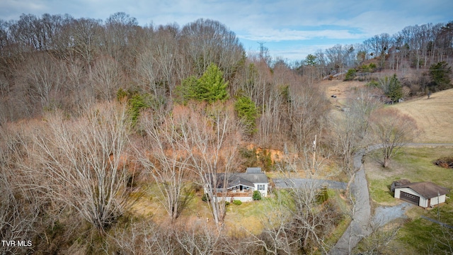 birds eye view of property with a view of trees