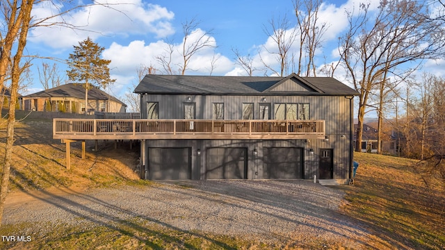 view of front of house featuring a garage, driveway, and a wooden deck