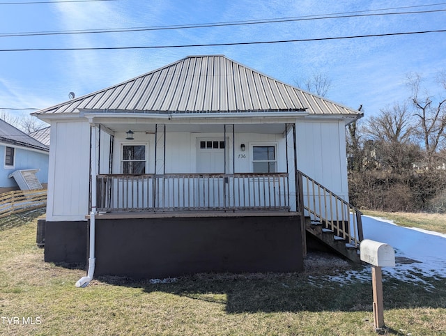 bungalow with metal roof, a porch, and a front yard