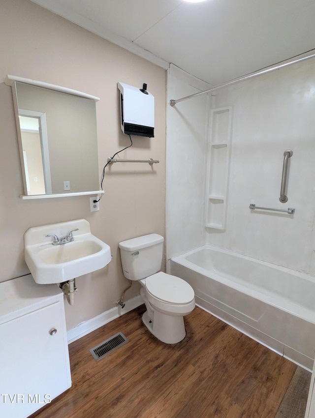 full bath with bathtub / shower combination, visible vents, toilet, and wood finished floors