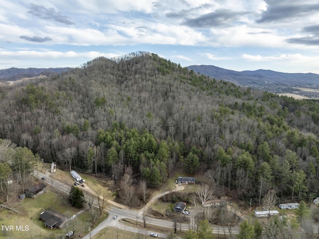 bird's eye view featuring a mountain view and a view of trees