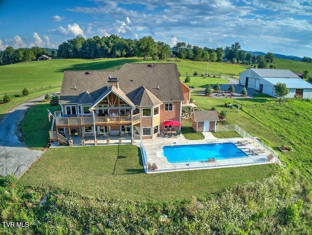 view of swimming pool featuring a lawn, stairway, a deck, an outdoor structure, and a patio area