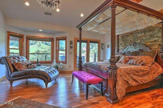 251 Fee Trl, Ewing, VA 24248 - bedroom with lofted ceiling, access to outside, visible vents, and wood finished floors