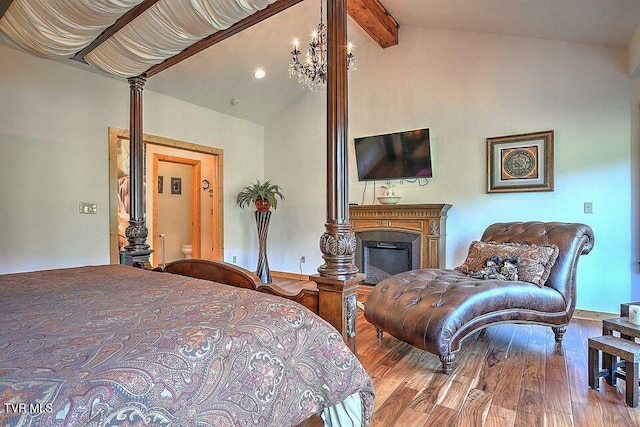 251 Fee Trl, Ewing, VA 24248 - bedroom with vaulted ceiling with beams, a chandelier, wood finished floors, and a glass covered fireplace