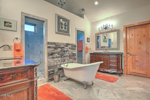 251 Fee Trl, Ewing, VA 24248 - bathroom featuring visible vents, vanity, vaulted ceiling, a textured ceiling, and a freestanding bath