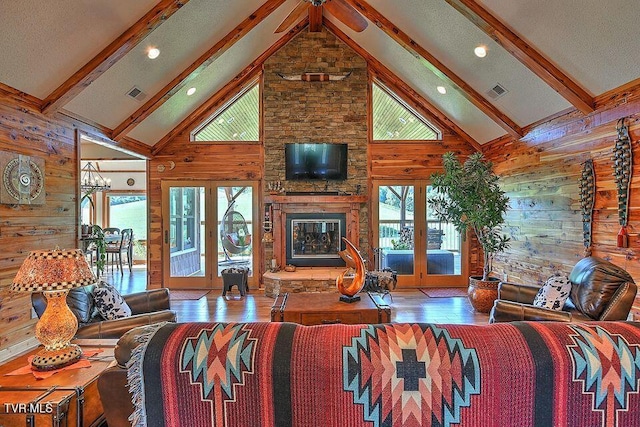 251 Fee Trl, Ewing, VA 24248 - living area featuring a stone fireplace, beam ceiling, and wooden walls