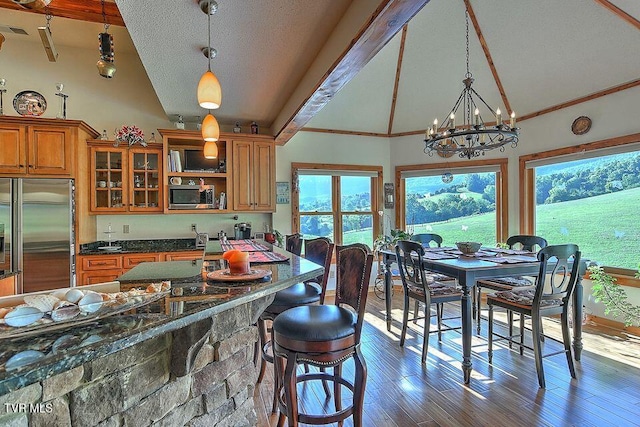 251 Fee Trl, Ewing, VA 24248 - kitchen with brown cabinetry, glass insert cabinets, wood finished floors, stainless steel appliances, and high vaulted ceiling