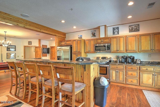 251 Fee Trl, Ewing, VA 24248 - kitchen with dark countertops, light wood-style flooring, appliances with stainless steel finishes, and brown cabinets