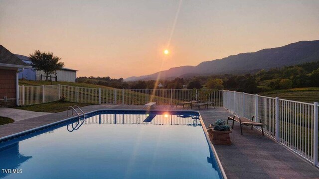 251 Fee Trl, Ewing, VA 24248 - pool at dusk featuring a fenced in pool, a mountain view, a patio, and fence