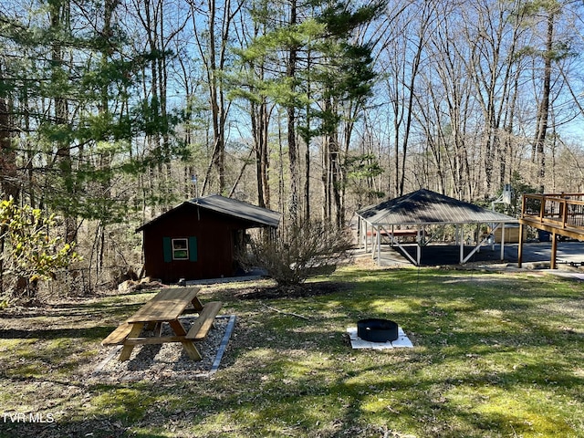 view of yard with a forest view and an outbuilding