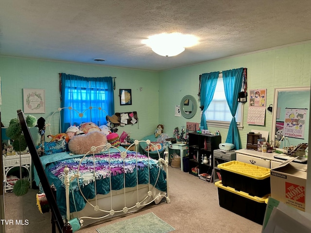 bedroom with a textured ceiling and carpet flooring