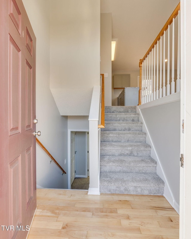 stairway featuring wood finished floors