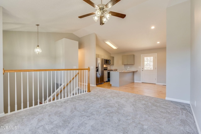 empty room featuring recessed lighting, light colored carpet, vaulted ceiling, baseboards, and ceiling fan with notable chandelier