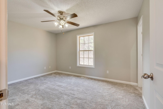 unfurnished room featuring ceiling fan, a textured ceiling, carpet, and baseboards