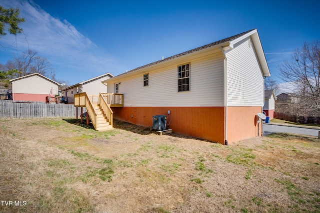 back of property featuring a deck, stairway, fence, and central air condition unit