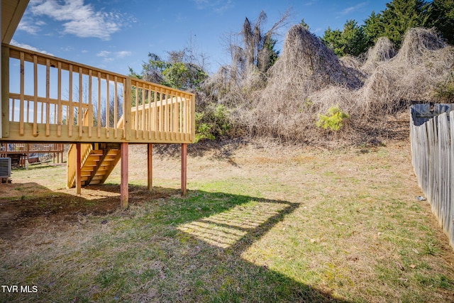 view of yard featuring fence, a deck, and stairs