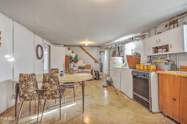 kitchen featuring black dishwasher, independent washer and dryer, light countertops, concrete flooring, and open shelves