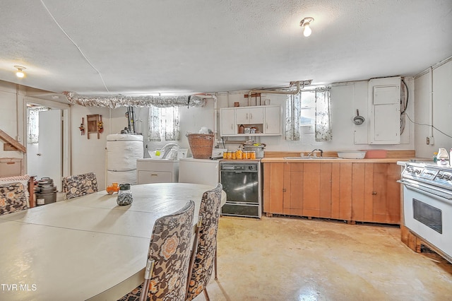 kitchen featuring a textured ceiling, concrete floors, a sink, washer and dryer, and white range with electric cooktop