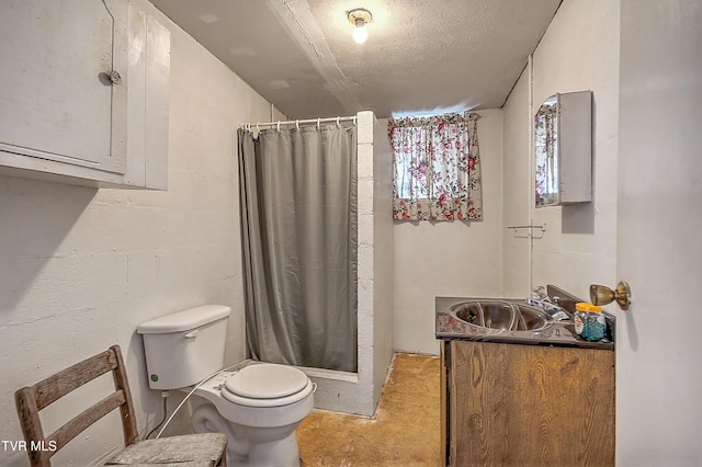 bathroom with unfinished concrete flooring, toilet, a shower stall, vanity, and a textured ceiling