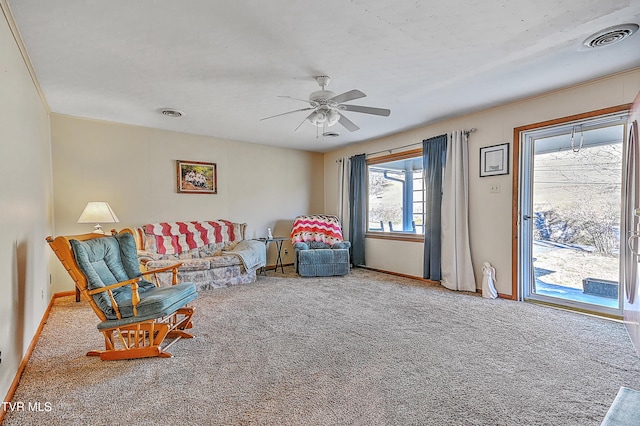 living room with a ceiling fan, carpet, visible vents, and baseboards