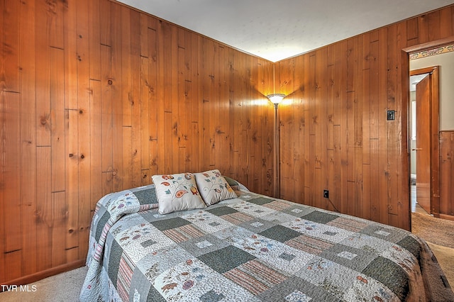 bedroom featuring carpet and wooden walls