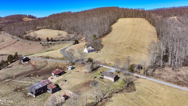 bird's eye view featuring a wooded view and a rural view