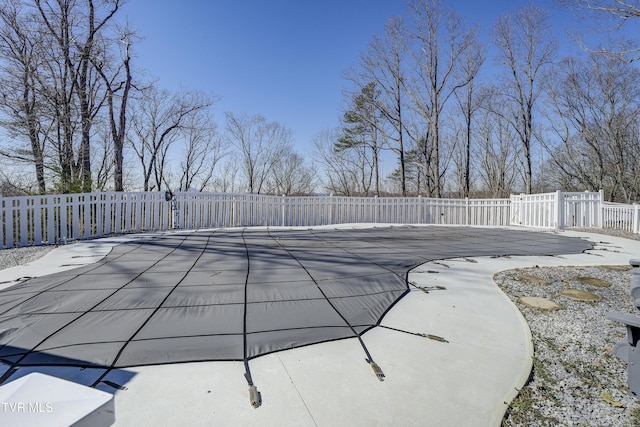 view of pool with a patio area and fence